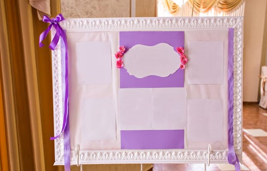 Original vintage white board with purple decoration and a guest list.