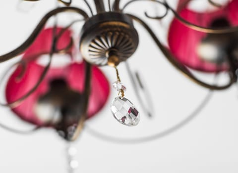 Close-up of a beautiful red chandelier. beautiful crystal chandelier in a room