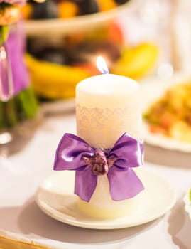 white wedding candles decoration with bright beautiful flowers