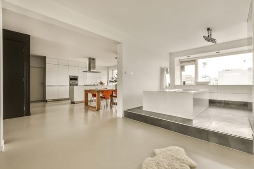 a kitchen and dining area in a modern style home with white walls, flooring and large windows overlooking out onto the street