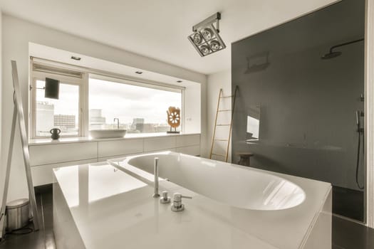 a modern bathroom with black walls and white fixtures in the bathtub is next to a window that looks out onto the citysca