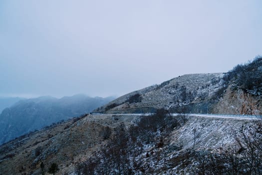 Road in the snowy mountains against the blue sky. High quality photo