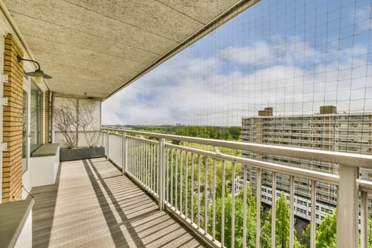 a balcony with some buildings in the background and blue skies overhead over the cityscapea photo taken from an apartment balcony