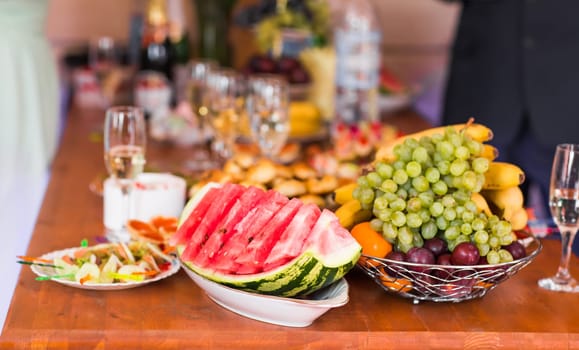 Holiday buffet food on the table. Fruit and appetizer