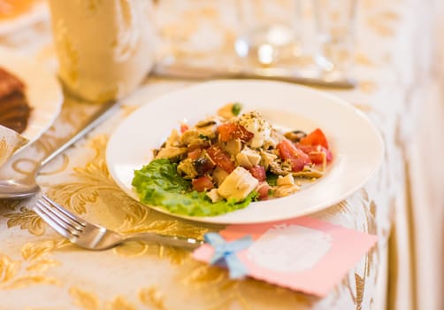 Salad with meat, mushrooms and tomatoes. Festive table