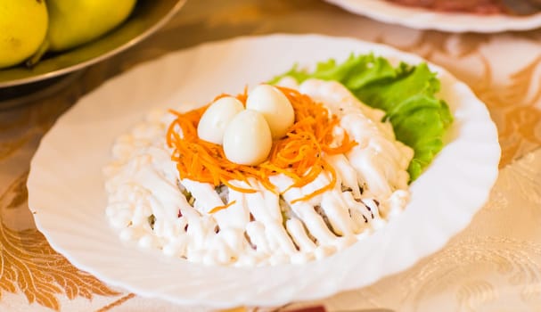 Salad with meat, mushrooms and eggs. Festive table