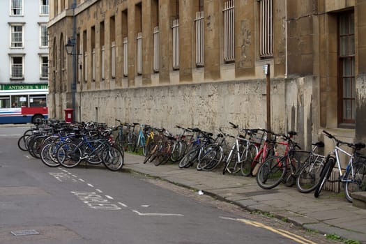 View of bicycles lined up against a wall in Oxford, England, UK