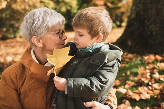 A french gray-haired grandmother with her grandson