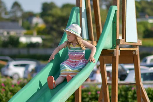Girl of three years old sliding outdoor Playground