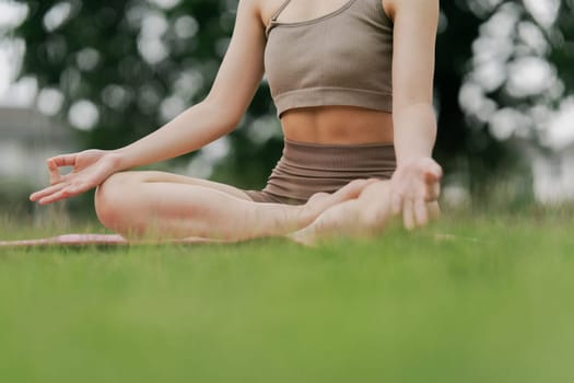 Asian woman wearing sportwear doing Yoga exercise in the nature.