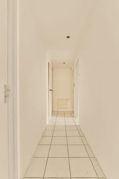 an empty room with white walls and tile flooring on the right side of the room, there is a door in the middle