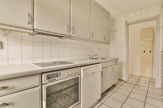 a kitchen with white tile flooring and appliances on the counters in front of the oven, door to the room is open