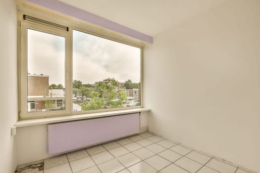 an empty room with white tile flooring and purple painted window sims on the right side of the room