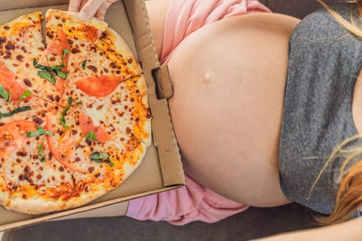 A pregnant woman enjoys a slice of pizza, savoring a moment of indulgence while satisfying her craving for a delightful, comforting treat. Excited Pregnant Young Lady Enjoying Pizza Holding Biting Tasty Slice Posing With Carton Box. Junk Food Lover Eating Italian Pizza. Unhealthy Nutrition Cheat Meal.