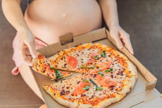 A pregnant woman enjoys a slice of pizza, savoring a moment of indulgence while satisfying her craving for a delightful, comforting treat. Excited Pregnant Young Lady Enjoying Pizza Holding Biting Tasty Slice Posing With Carton Box. Junk Food Lover Eating Italian Pizza. Unhealthy Nutrition Cheat Meal.