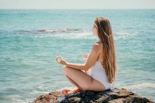 Woman travel sea. Young Happy woman in a long red dress posing on a beach near the sea on background of volcanic rocks, like in Iceland, sharing travel adventure journey