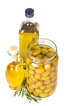Green olives preserved in bank, bottle of olive oil, rosemary isolated on a white background