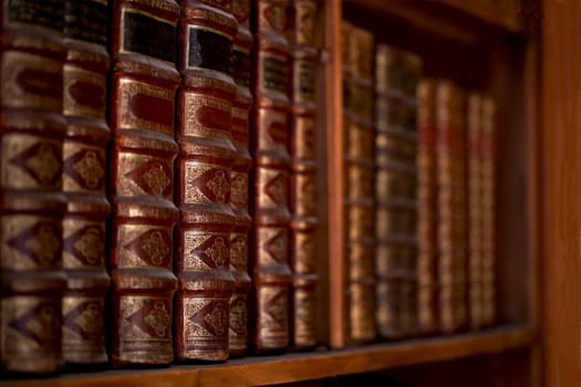 Vienna, Austria: Old bookcase with the leather-bound book covers in State Hall of Austrian National Library