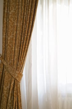 Beautiful brown curtains with a pattern. eautiful curtains that would be the perfect addition to any home.