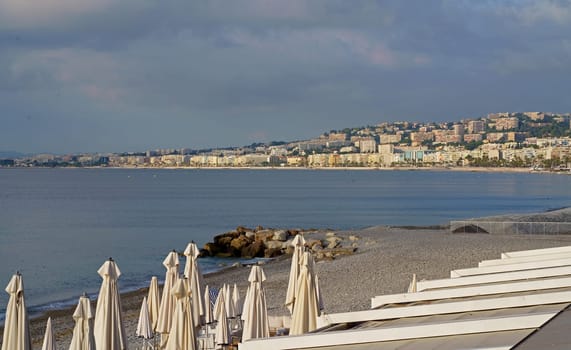 Nice, France: View of the beach with sun loungers and umbrellas in Nice. The beach and Promenade des Anglais are busy almost all year round.