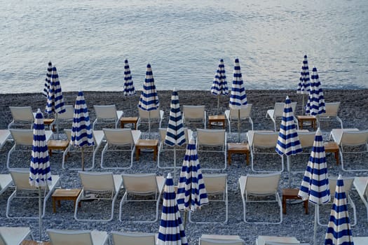 Nice, France: View of the beach with sun loungers and umbrellas in Nice. The beach and Promenade des Anglais are busy almost all year round.