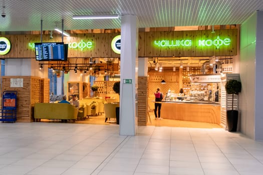 13.06.2023, Novosibirsk, Russia. People sit in a cozy cafe at the airport of Novosibirsk. A coffee shop where you can eat, drink beer or coffee before departure.