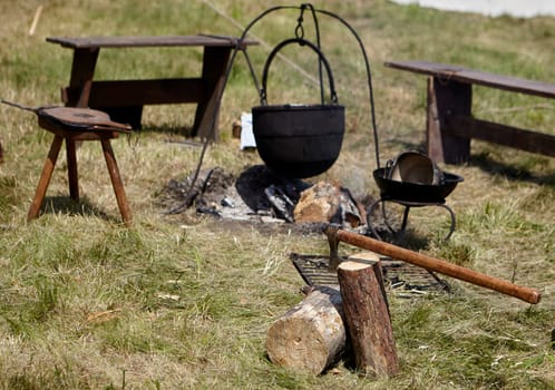 Camping. Soup in a pot over a fire. Stylization under the Middle Ages, vintage.