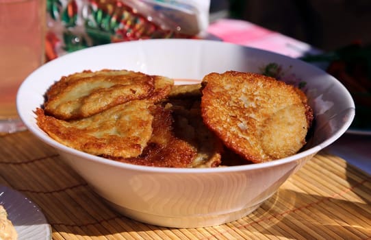 Potato cakes. Vegetable fritters, latkes, pancakes. Vegetable pancakes. On the table in a white plate.