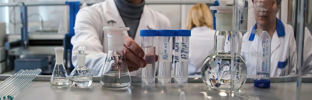 The doctor takes a test tube with liquid, close-up. Work in a chemical laboratory. Laboratory analysis