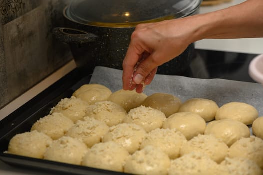 woman sprinkles buns in the kitchen 3