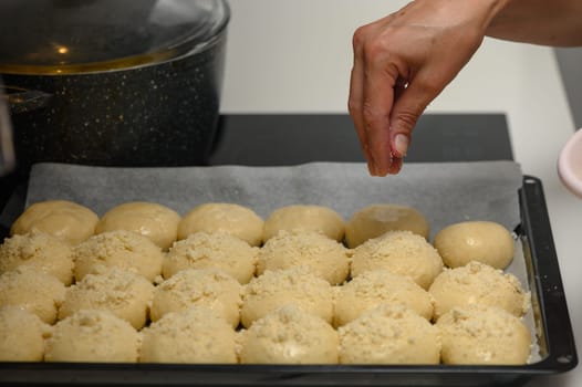 woman sprinkles buns in the kitchen 4