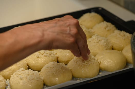 woman sprinkles buns in the kitchen 5