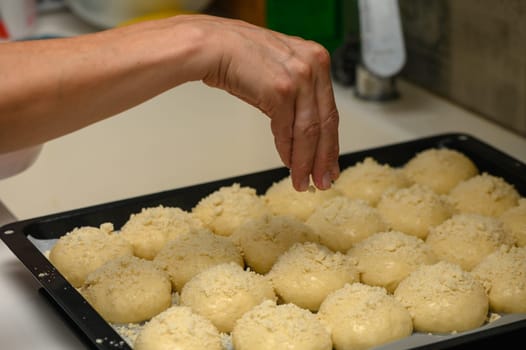 woman sprinkles buns in the kitchen 6