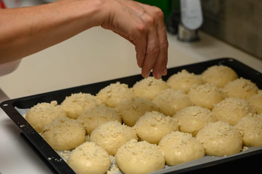 woman sprinkles buns in the kitchen 7