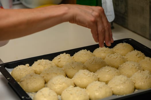 woman sprinkles buns in the kitchen 9