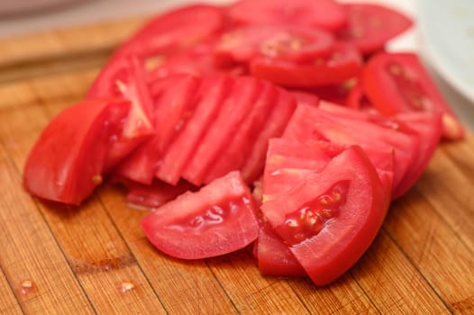 woman cutting tomato on kitchen board 8