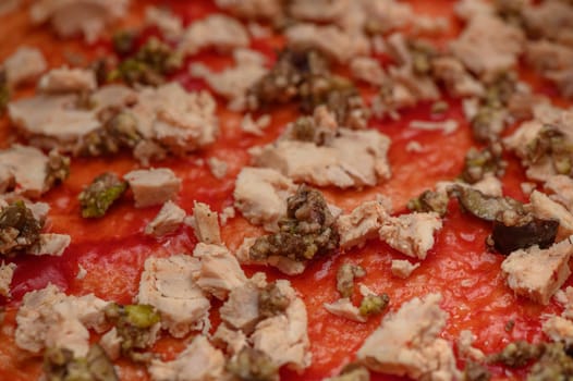 a woman prepares pizza with cheese, tomatoes and chicken ham, a woman lays out chicken ham 5