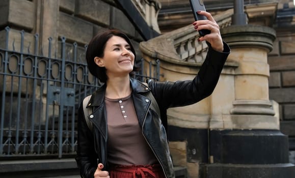 Attractive Woman Strolls In Dresden'S Touristic Center, Capturing Photos Of City'S Sightseeing Spots