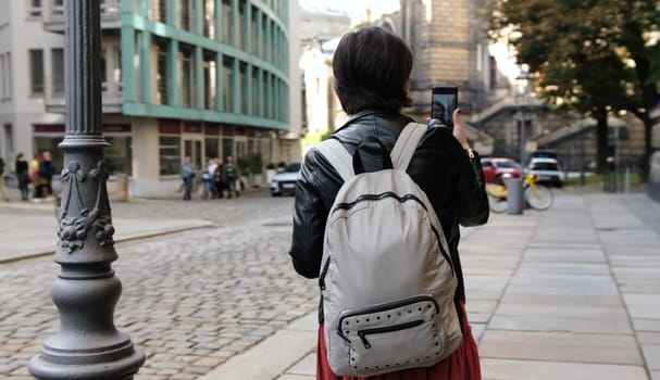 Attractive Woman With Backpack Walks On Street In Online Video Streaming