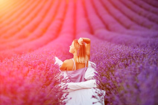 Woman lavender field. A middle-aged woman sits in a lavender field and enjoys aromatherapy. Aromatherapy concept, lavender oil, photo session in lavender.