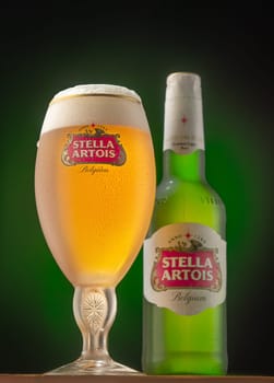 Severodonesk/ukraine 01.22.2021-beer Stella Artois in a glass and bottle on a green background