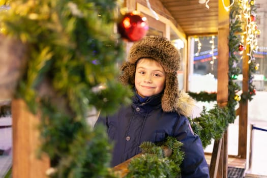 Boy in a winter hat at the New Year's fair. High quality photo