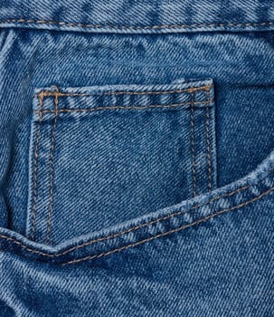 Blue jeans front pocket with buttons, close up