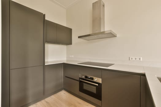 a modern kitchen with black cabinets and white counter tops on the island in this contemporary kitchen is very well organized