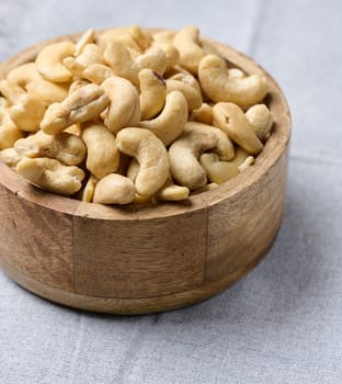 Cashews in a wooden bowl on the table