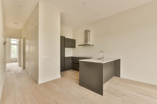 an empty kitchen and dining area in a new house with white walls, hardwood flooring and light wood floors