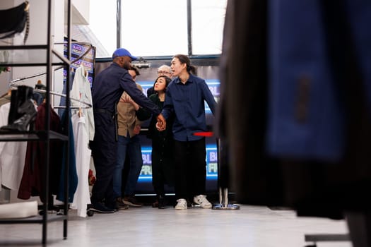 Security guard opening clothing store for happy excited customers on Black Friday, letting eager frenzy shoppers to enter clothing store. Crazy diverse crowd breaking into mall during seasonal sales