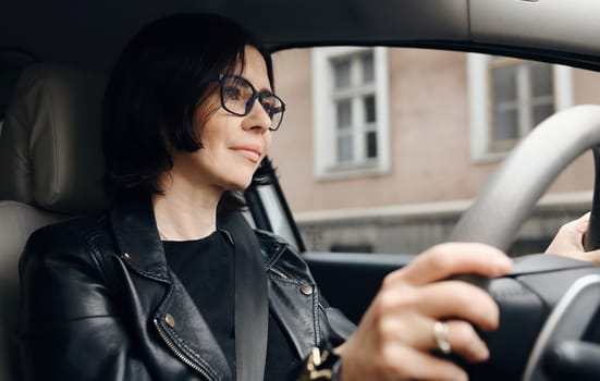 Attractive Business Woman Driving A Car By Modern City