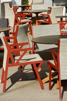 Empty stylish red chairs in one of the restaurants in Monaco on a sunny day. High quality photo