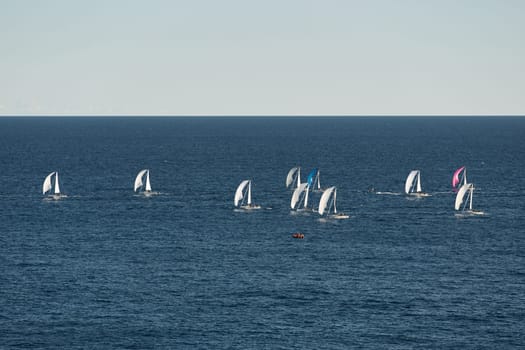A lot of sail boats and yachts in the sea went on a sailing trip near port Hercules in Monaco, Monte Carlo, sail regatta, race. High quality photo